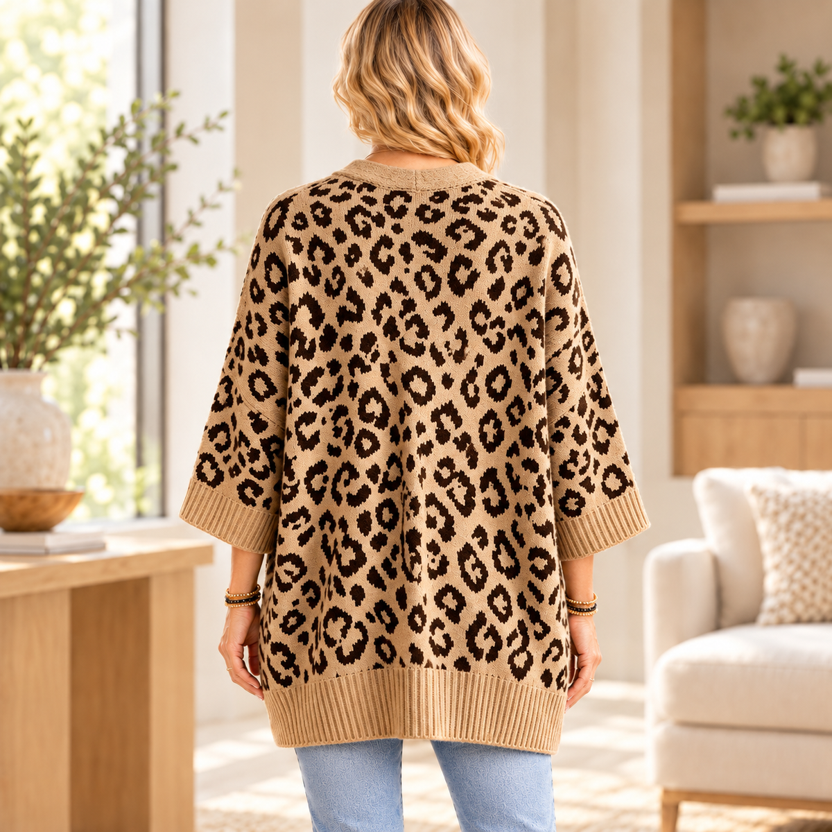 Tan leopard knit cardigan, back view in warm interior